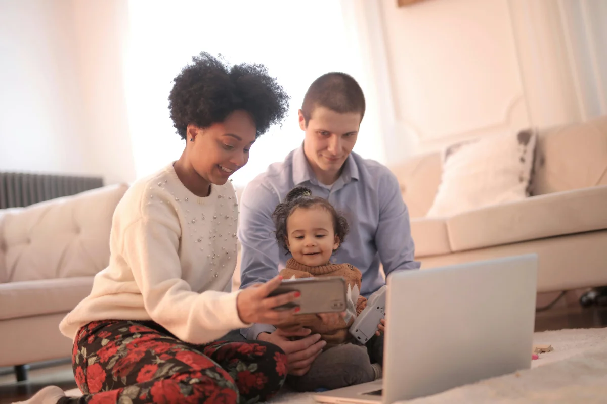 Happy parents viewing photos of their child